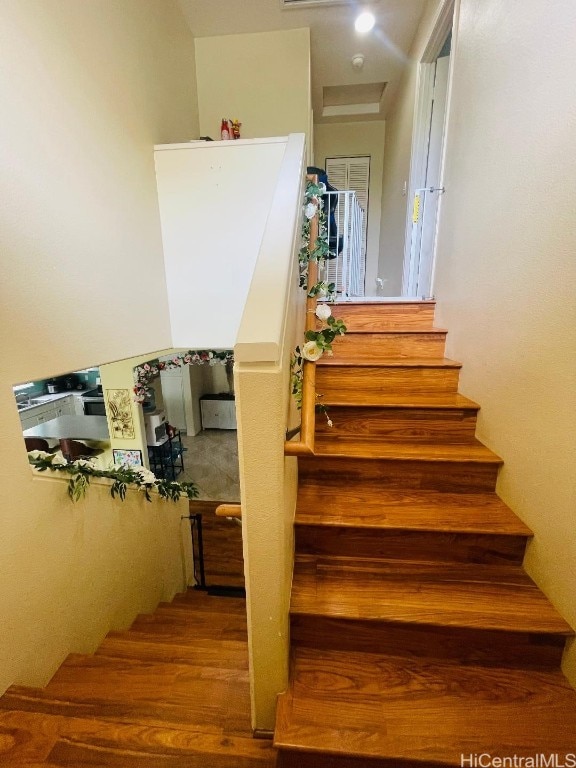 stairs featuring hardwood / wood-style floors