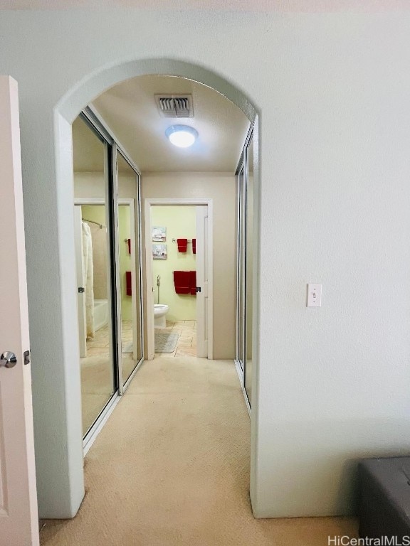 hallway with light colored carpet