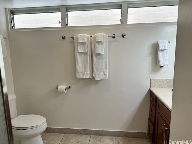 bathroom featuring vanity, tile patterned floors, and toilet