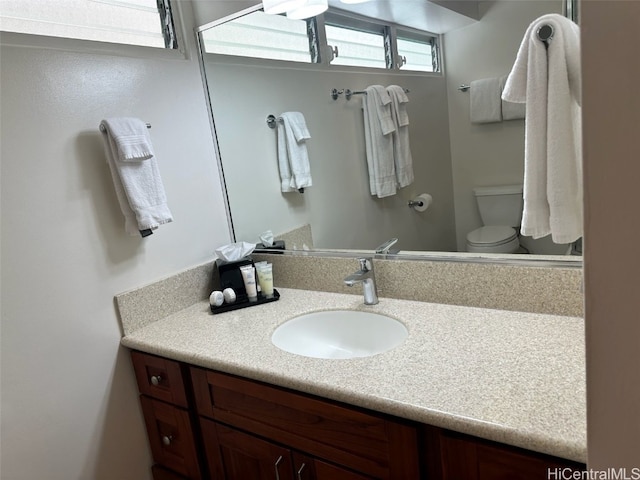 bathroom with vanity and toilet