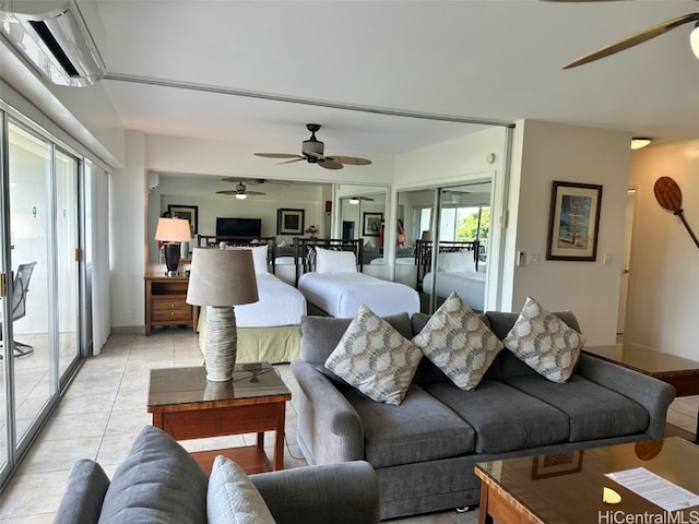 tiled living room with ceiling fan, a healthy amount of sunlight, and a wall mounted AC