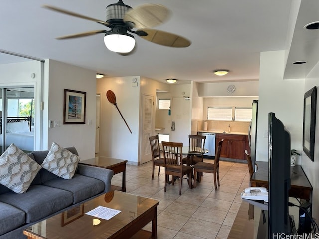 tiled living room with ceiling fan and sink