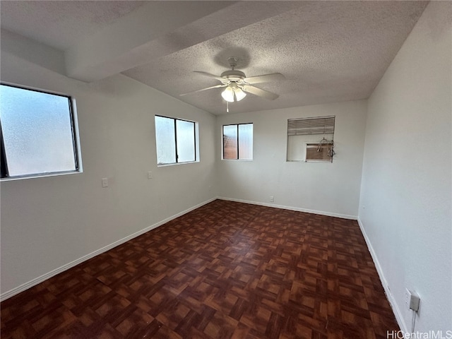 unfurnished room with dark parquet floors, a textured ceiling, and ceiling fan