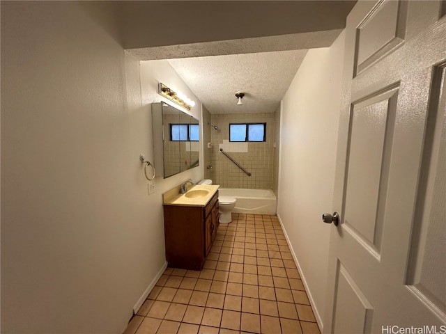 full bathroom with toilet, tile patterned floors, tiled shower / bath, a textured ceiling, and vanity