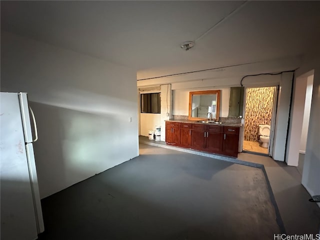 kitchen featuring sink and stainless steel refrigerator