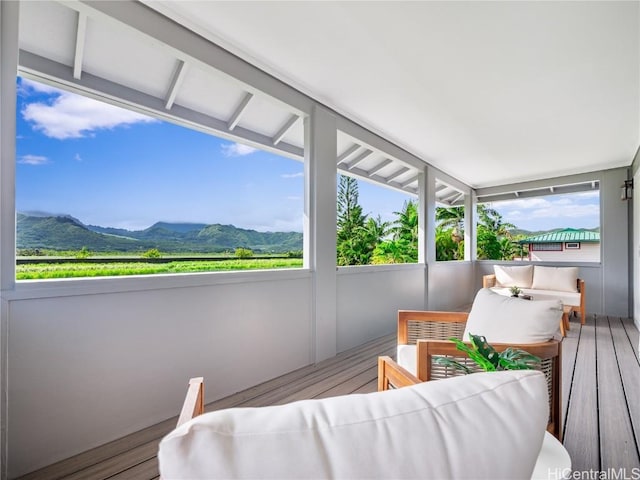 sunroom featuring a mountain view and a healthy amount of sunlight