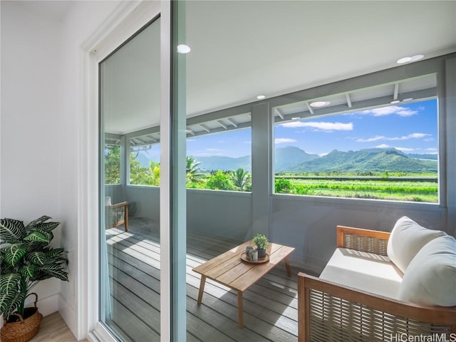 sunroom / solarium with a mountain view and a wealth of natural light