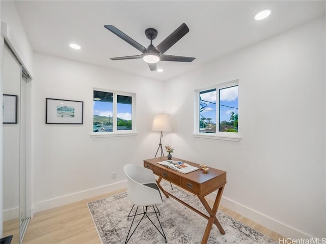 home office with ceiling fan and light wood-type flooring