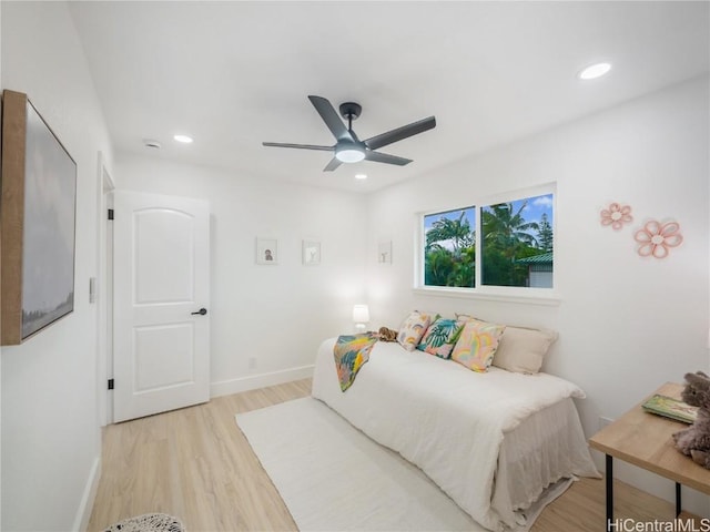 bedroom with ceiling fan and light hardwood / wood-style flooring