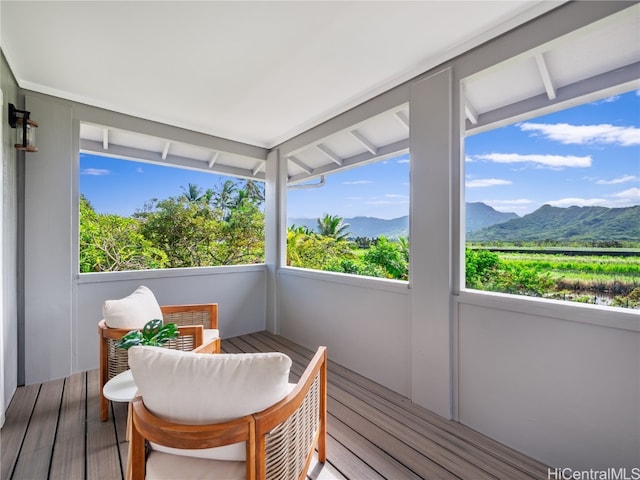 sunroom / solarium with a mountain view and plenty of natural light