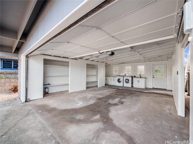 garage with washer and dryer and a garage door opener