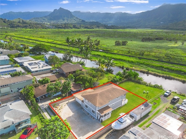 drone / aerial view with a water and mountain view