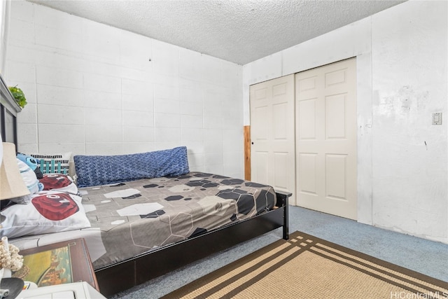 bedroom featuring a closet, a textured ceiling, and carpet floors