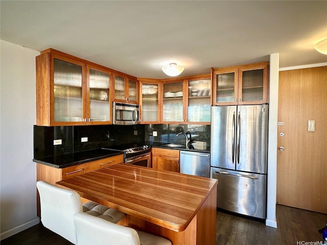411 Hobron Ln Unit 912, Honolulu, HI 96815 - kitchen featuring appliances with stainless steel finishes, tasteful backsplash, glass insert cabinets, dark wood finished floors, and brown cabinetry