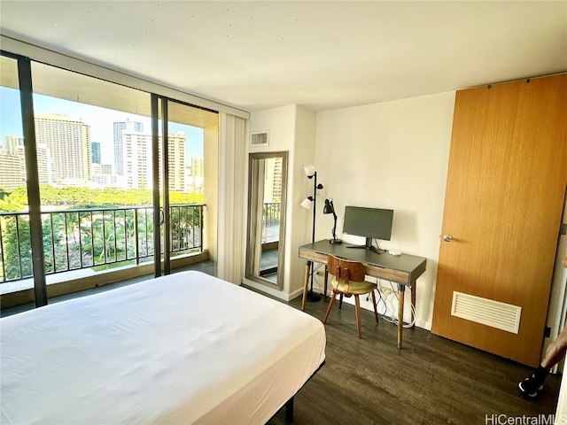 bedroom with access to exterior, dark hardwood / wood-style flooring, and floor to ceiling windows