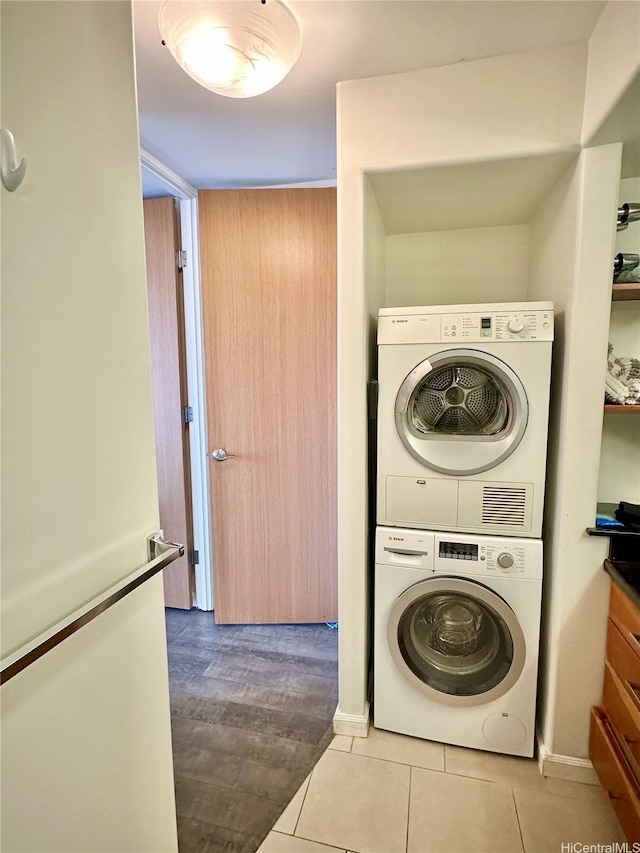 411 Hobron Ln Unit 912, Honolulu, HI 96815 - laundry area featuring stacked washer / dryer and tile patterned floors