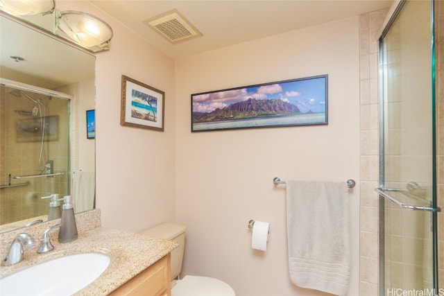 bathroom featuring toilet, an enclosed shower, and vanity