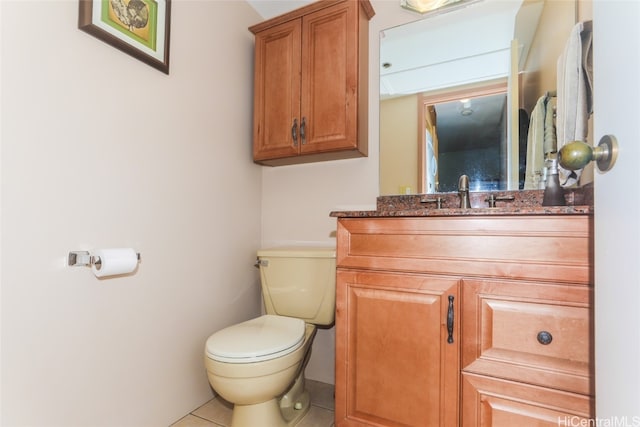 bathroom with tile patterned flooring, vanity, and toilet