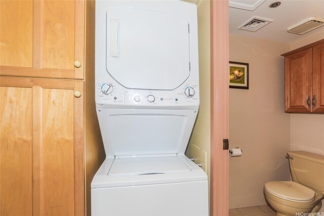 1088 Bishop St Unit 1125, Honolulu, HI 96813 - laundry area featuring stacked washer and clothes dryer and tile patterned floors