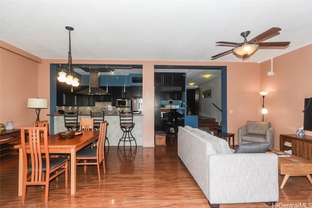 living room with ceiling fan and hardwood / wood-style flooring