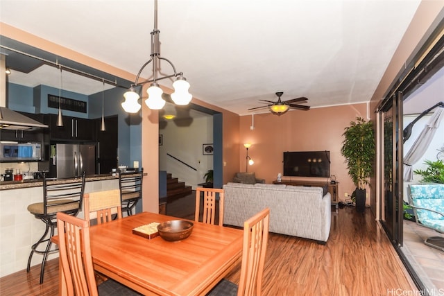 dining area featuring hardwood / wood-style flooring and ceiling fan