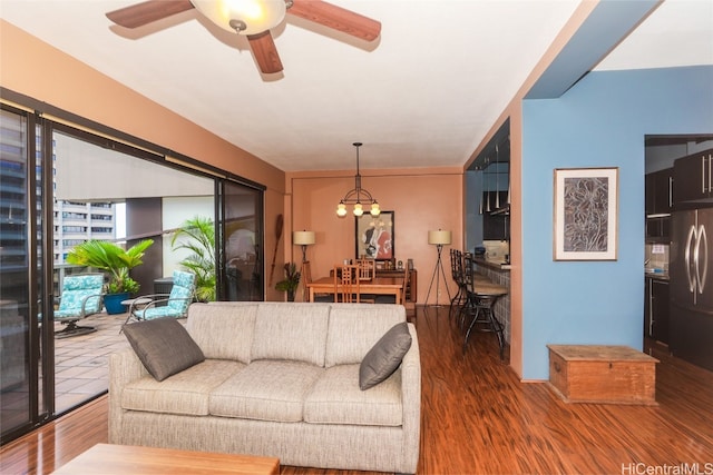 living room featuring hardwood / wood-style floors and ceiling fan