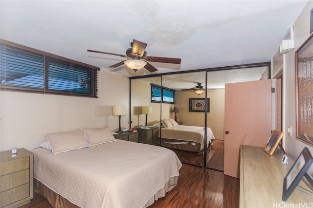 bedroom featuring hardwood / wood-style flooring, ceiling fan, and a closet