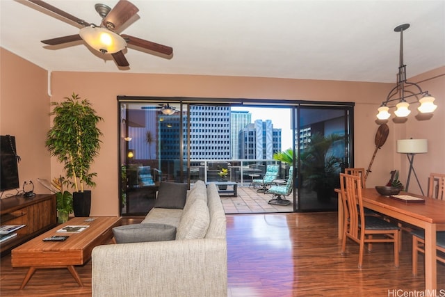 living room featuring hardwood / wood-style floors and ceiling fan