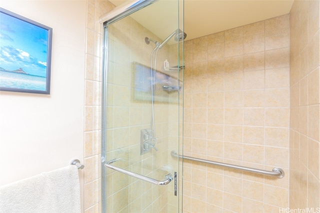 bathroom featuring a shower with shower door