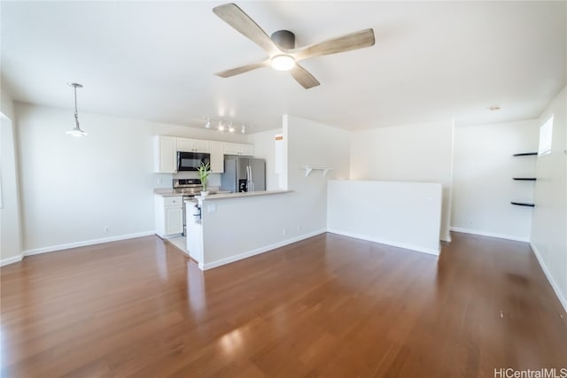 unfurnished living room with dark wood-type flooring and ceiling fan