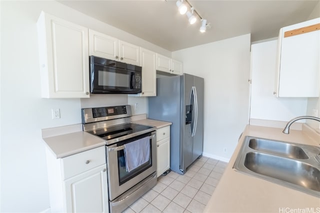 kitchen with white cabinetry, appliances with stainless steel finishes, sink, and light tile patterned floors