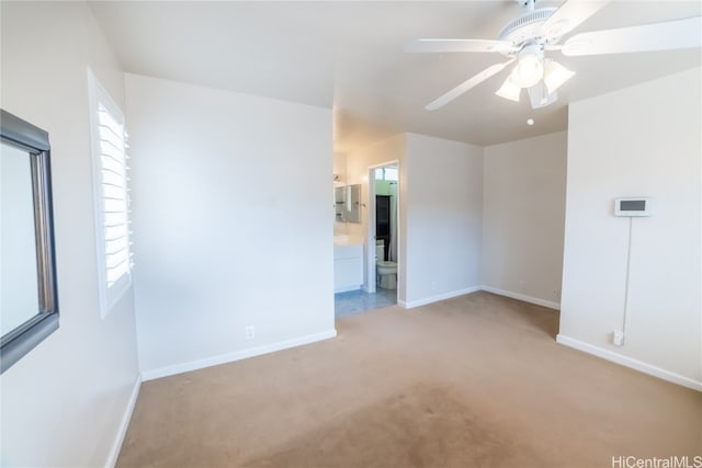 unfurnished room featuring light carpet and ceiling fan