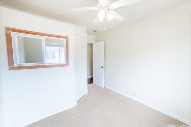 empty room with light carpet and ceiling fan