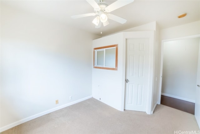 unfurnished bedroom with light carpet, ceiling fan, and a closet