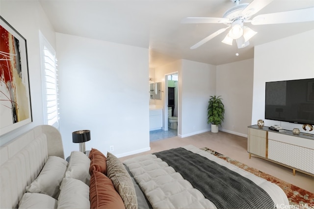 bedroom featuring ensuite bath, ceiling fan, and light colored carpet