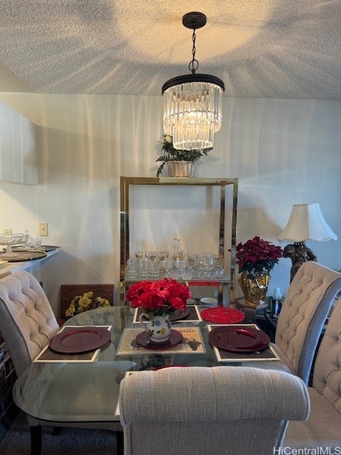 dining room featuring a notable chandelier and a textured ceiling