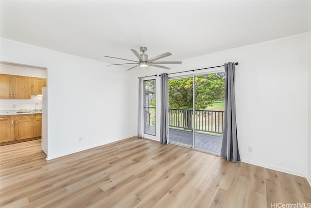 interior space with light hardwood / wood-style floors, ceiling fan, and crown molding