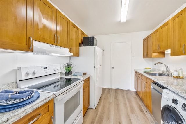 kitchen with light stone counters, light wood-type flooring, white electric stove, washer / clothes dryer, and sink