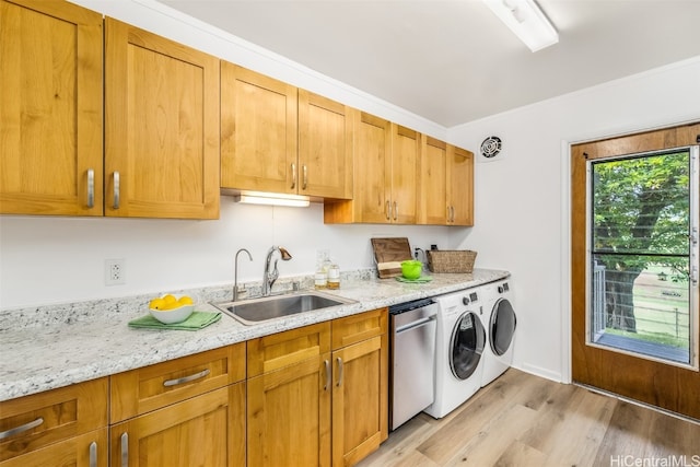 laundry room with separate washer and dryer, sink, light hardwood / wood-style flooring, and ornamental molding