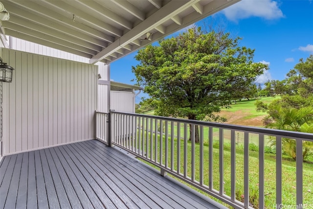 wooden terrace featuring a lawn