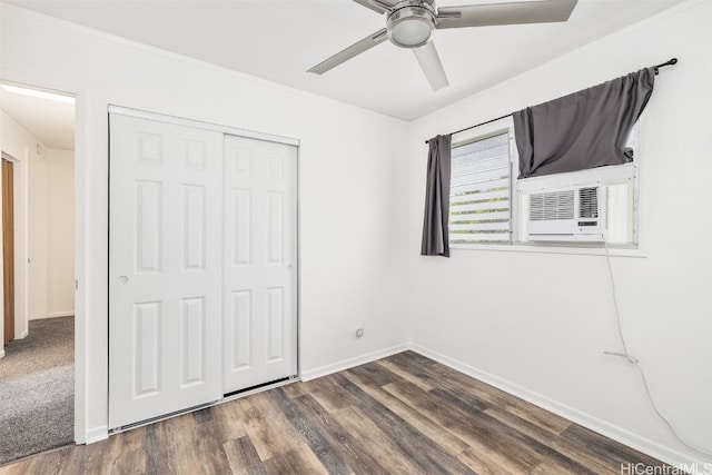 unfurnished bedroom with dark wood-type flooring, a closet, and ceiling fan