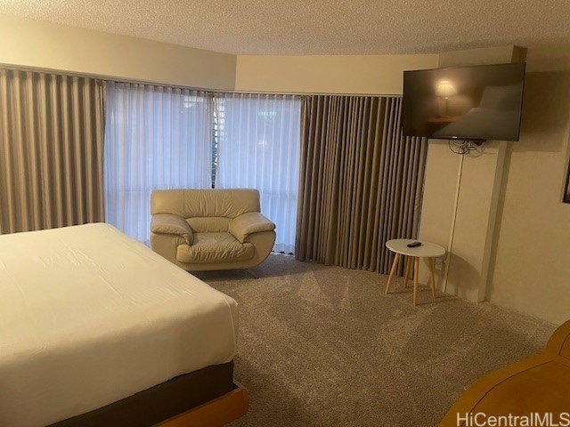bedroom with a textured ceiling and carpet floors