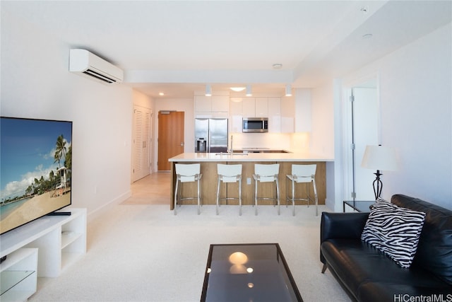 carpeted living room with an AC wall unit and sink