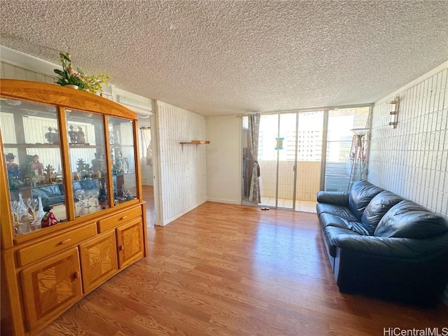 living room featuring light hardwood / wood-style flooring and a textured ceiling