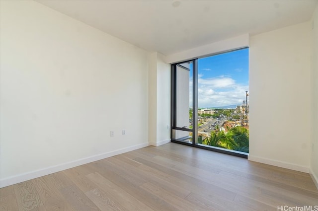 unfurnished room featuring light hardwood / wood-style floors