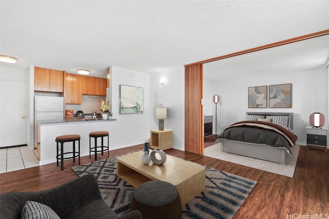 living room with a textured ceiling and light hardwood / wood-style flooring