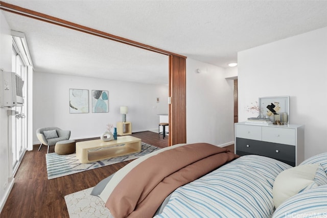 bedroom with a textured ceiling and dark wood-type flooring