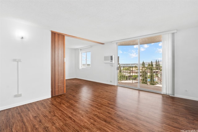 98-1038 Moanalua Rd Unit 1102, Aiea, HI 96701 - empty room with wood finished floors, a wall of windows, baseboards, and an AC wall unit