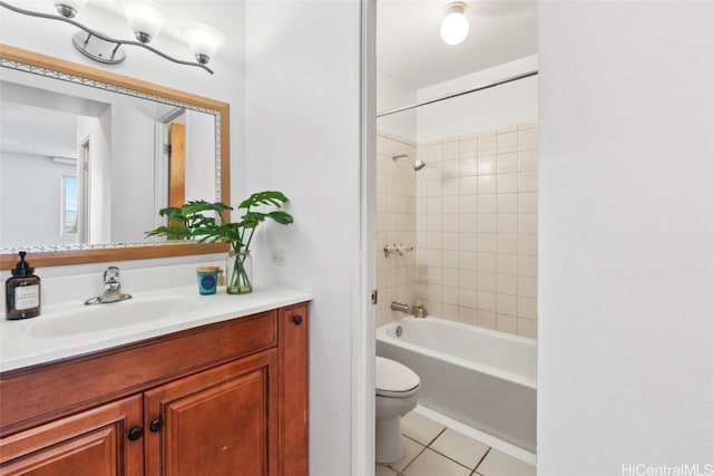 full bathroom with vanity, toilet, tiled shower / bath, and tile patterned flooring