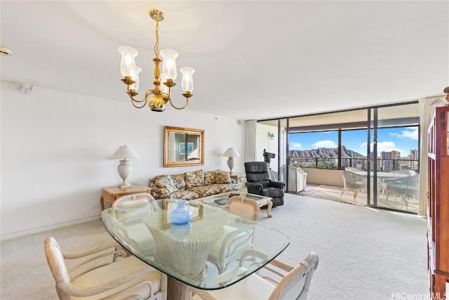 carpeted dining space featuring expansive windows and a notable chandelier